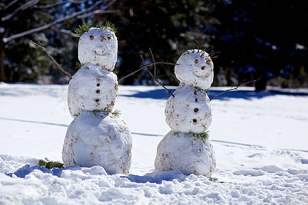 two snowmen near trees thumbnail