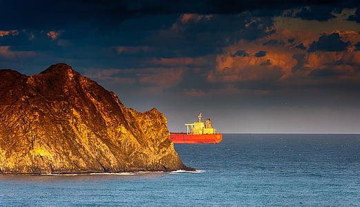 red and white boat and rock formation thumbnail