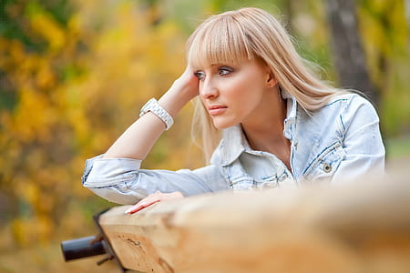 selective focus photography of woman wearing blue denim button-up jacket thumbnail