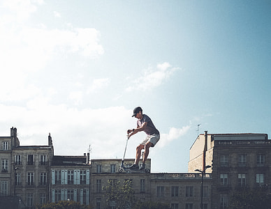 person riding kick scooter on top of building illustration thumbnail