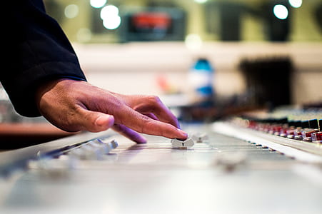 shallow focus photography of person holding audio mixer thumbnail