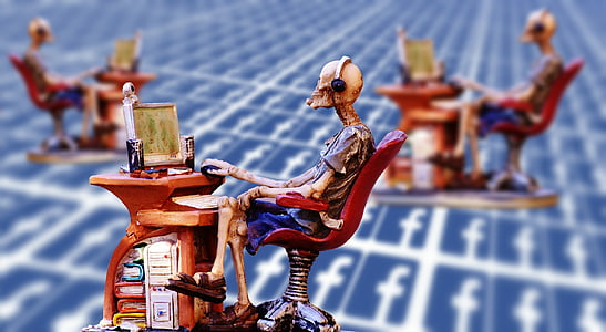 shallow focus photo of skeleton on chair miniature decor thumbnail