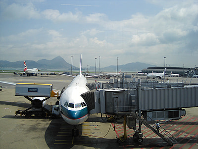 white airliner beside grey machine thumbnail
