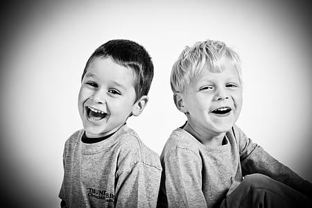 two boys smiling grayscale photography thumbnail