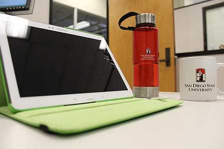 white Samsung Tab beside red tumbler and white mug thumbnail