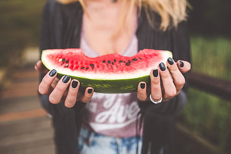 woman holding slice of watermelon thumbnail