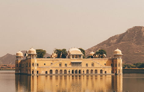 photography of brown concrete building surrounded of body of water thumbnail