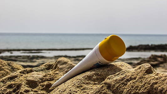 shallow focus photography of white tube bottle in seashore thumbnail