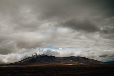 landscape photography of mountain under cloudy sky during daytime thumbnail