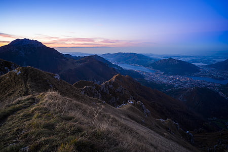 body of water in between mountains at golden hour thumbnail