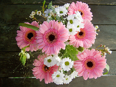 white and pink petaled flowers on desk thumbnail