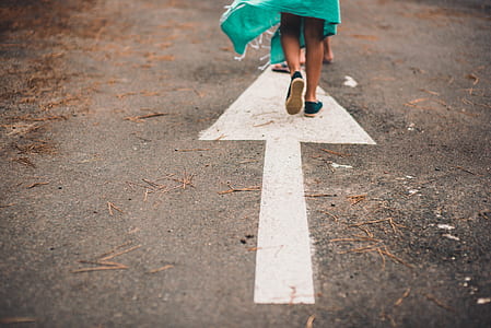 person walking on gray road thumbnail