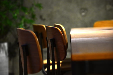 selective focus photography of brown wooden chairs thumbnail