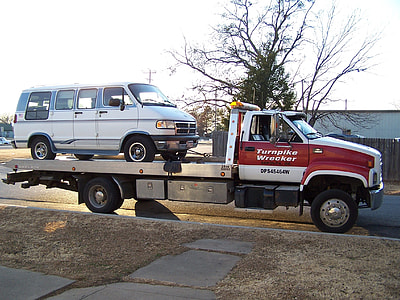 red and white truck park near house thumbnail