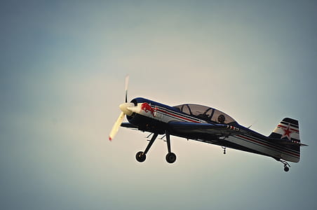 black and gray airplane flying through sky thumbnail