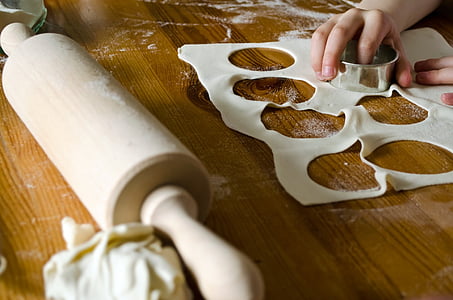 rolling pin and dough on wooden table thumbnail