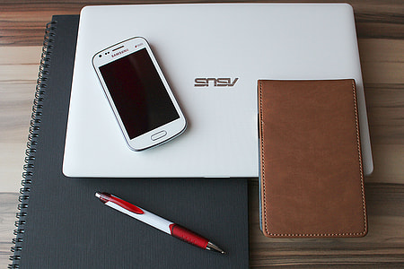 white Samsung Duos smartphone with white Asus laptop computer thumbnail
