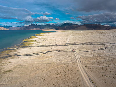 areal view of beige land near sea thumbnail