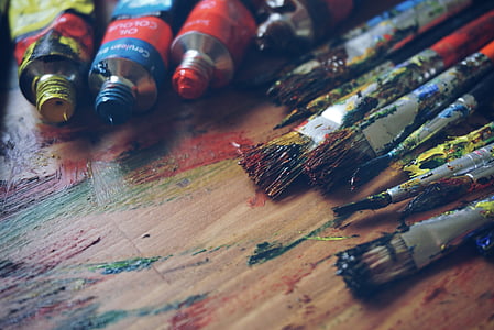 assorted-color paintbrush and paint on brown wooden parquet thumbnail
