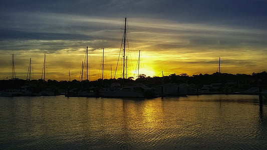 silhouette photo of dock during golden hour thumbnail