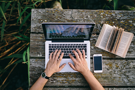 Man working on Macbook at lake thumbnail