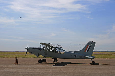 gray biplane on brown field during daytime thumbnail