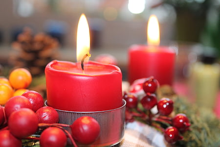red candle lit beside fruits thumbnail