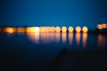 City lights reflected in the water at night thumbnail