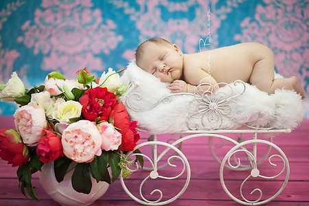 baby sleeping on top of white pram thumbnail