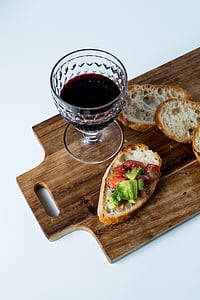 clear wine glass beside breads thumbnail