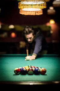 man playing billiard inside room thumbnail