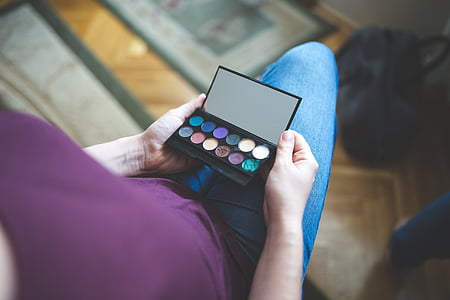 person holding eyeshadow palette thumbnail