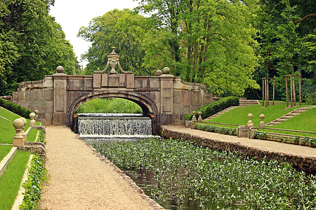 brown bridge above water with flowers landscape photography thumbnail