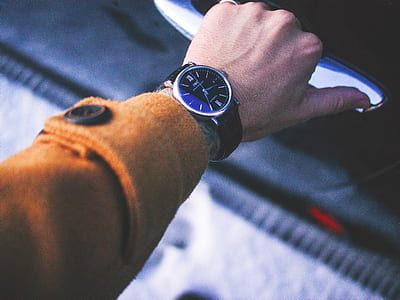 photo of person wearing black analog watch thumbnail