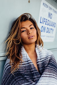 woman in white, gray, and black top thumbnail
