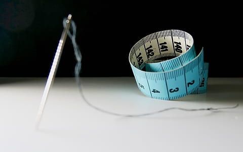 needle and tape measure on tale thumbnail