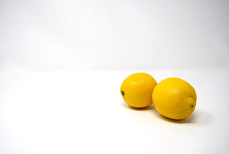 two ripe lemons on white surface thumbnail