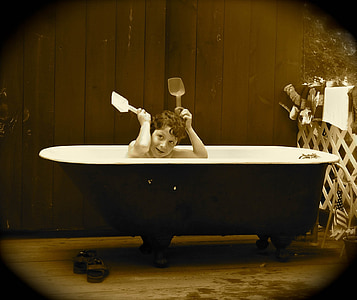 sepia photo of boy on bathtub thumbnail