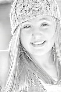 grayscale photo of smiling woman wearing knitted beanie thumbnail