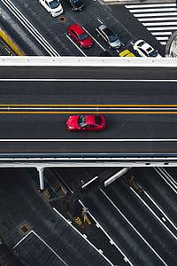 red car in gray concrete road thumbnail