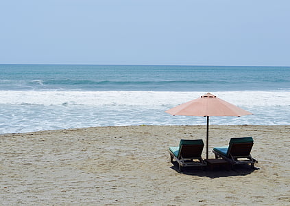 two blue sun lounge chair at seashore thumbnail