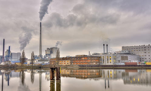 factories beside body of water thumbnail