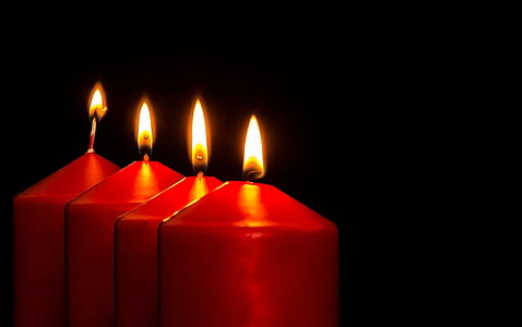four red lighted pillar candles thumbnail