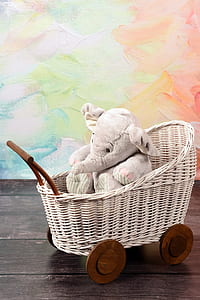 elephant plush toy on white wicker stroller thumbnail
