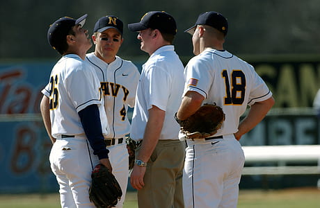 four baseball players talking on field thumbnail