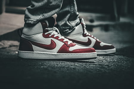 selective focus photography of pairs of white-and-red Nike sneakers thumbnail