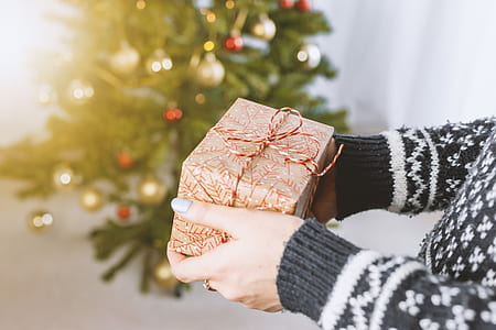 person holding brown gift box thumbnail