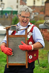 man holding brown washboard thumbnail