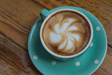 white and teal teacup filled on green saucer thumbnail