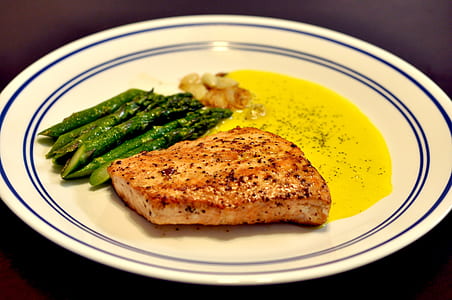 slice meat with asparagus in white ceramic plate thumbnail